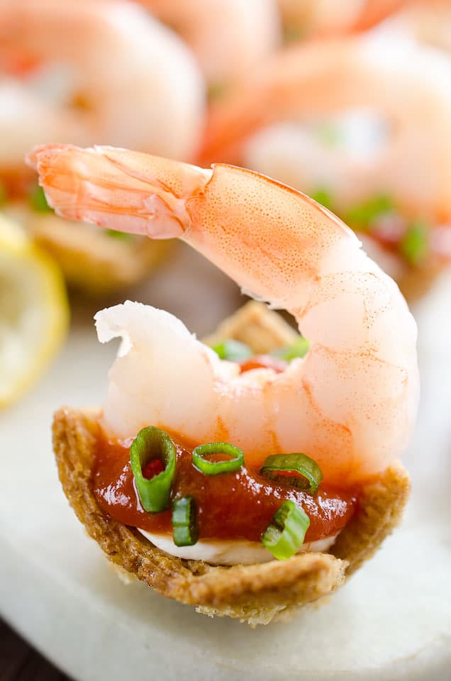 Light Shrimp Cocktail Bites are the perfect finger food to celebrate a holiday party. These individual bites of shrimp cocktail are lightened up with reduced fat cream cheese and Greek yogurt for a delicious and guilt free finger food you can enjoy!