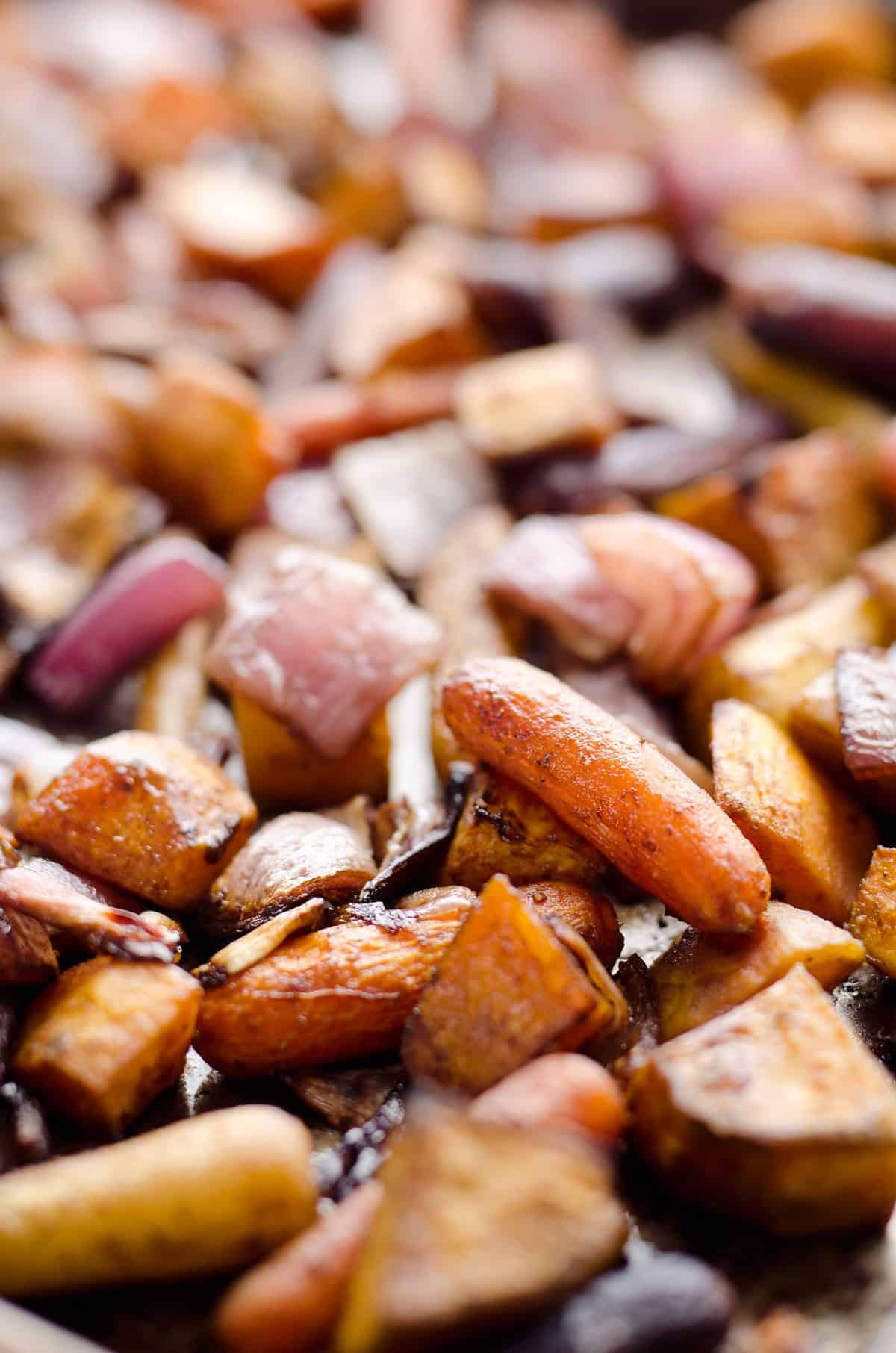 Balsamic Dijon Roasted Root Vegetables is an easy and healthy side dish bursting with tangy balsamic flavor and loaded with sweet potatoes, carrots and onions.