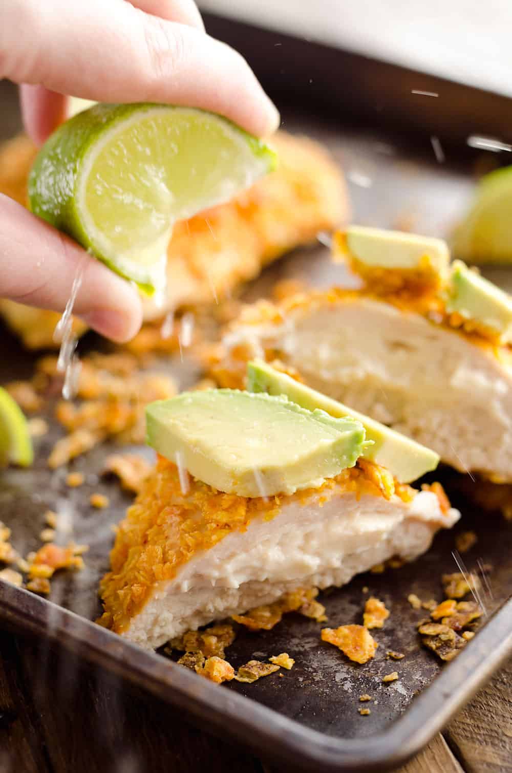 {3 Ingredient} Cheesy Dorito Chicken is a light and delicious dinner with tender chicken breasts stuffed with a creamy queso fresco cheese and coated in crunchy Dorito chips.
