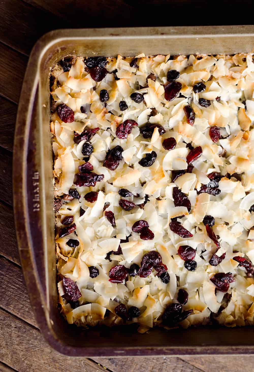 Berry Coconut Magic Bars are amazingly easy to whip together and have the great flavors of chocolate and dried berries for a fun twist on a classic dessert.
