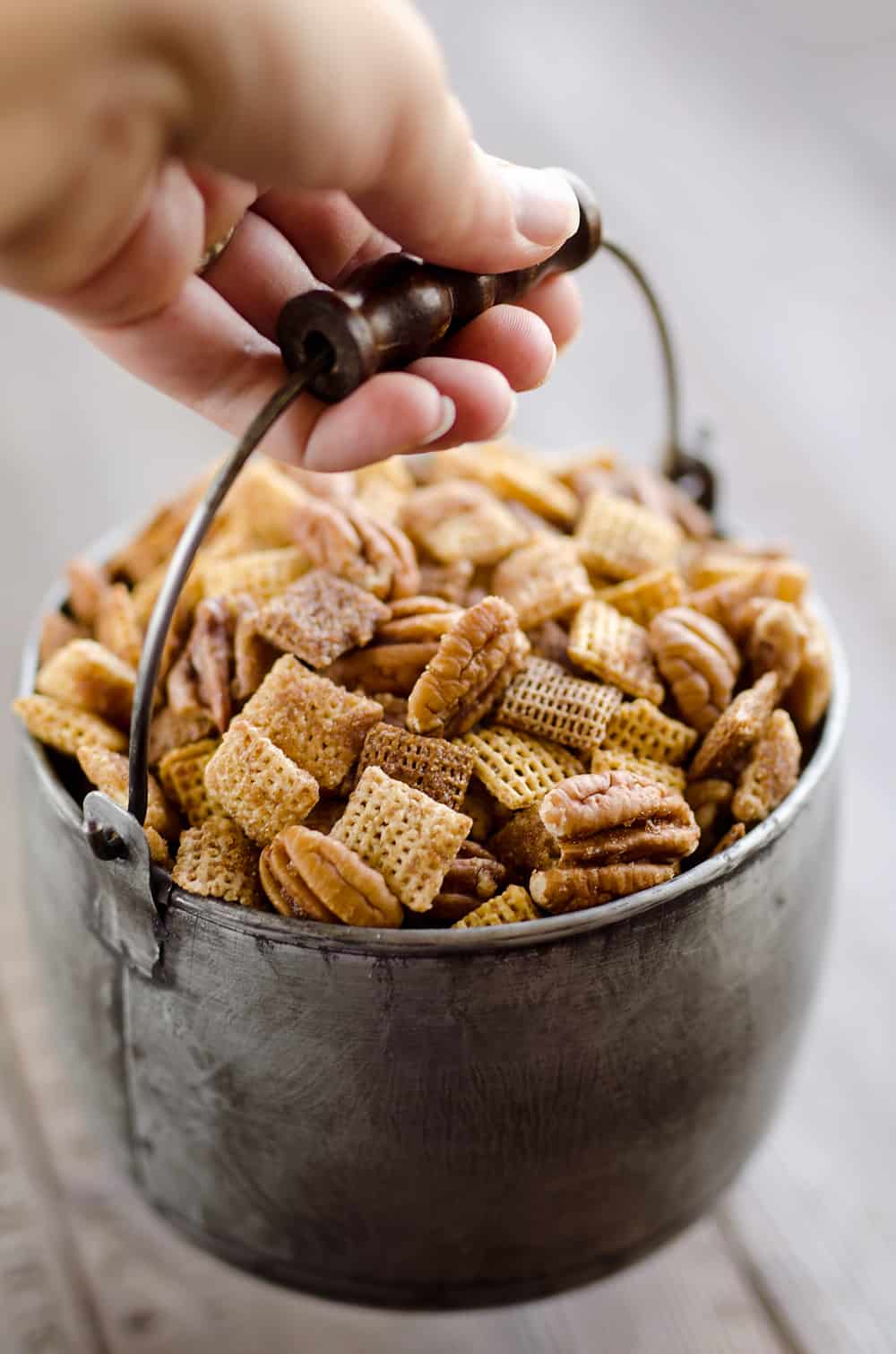 Sweet & Spicy Pecan Snack Mix is a delicious treat with Chex coated in a spicy cinnamon brown sugar mixture and tossed with pecans. This delicious Chex Mix will disappear quickly at your next holiday gathering!
