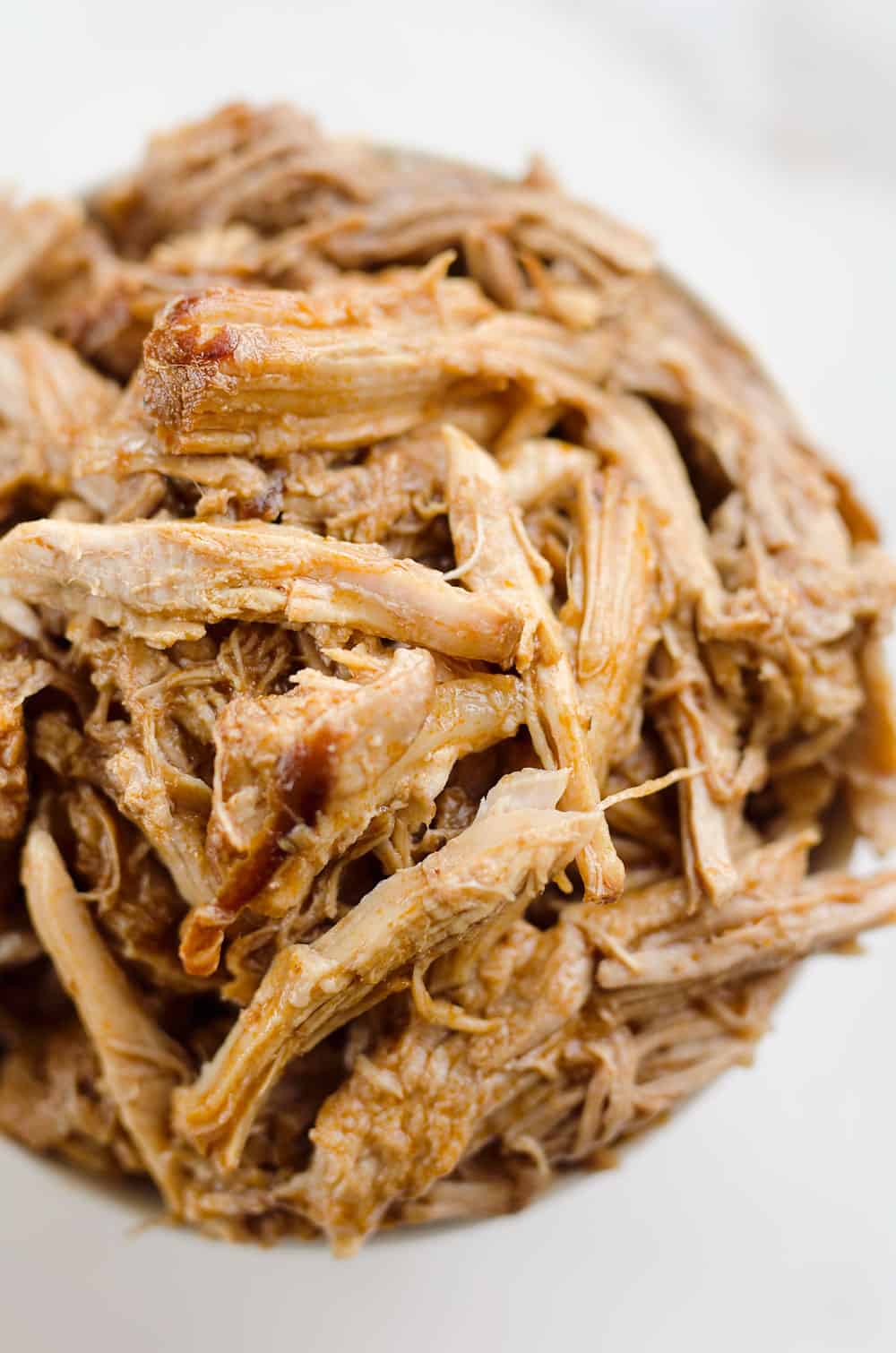 Pressure Cooker BBQ Pulled Pork is an easy three ingredient recipe that makes for tender and delicious pork that is perfect for sandwiches or wonderful paired with rice and vegetables for a healthy dinner idea.