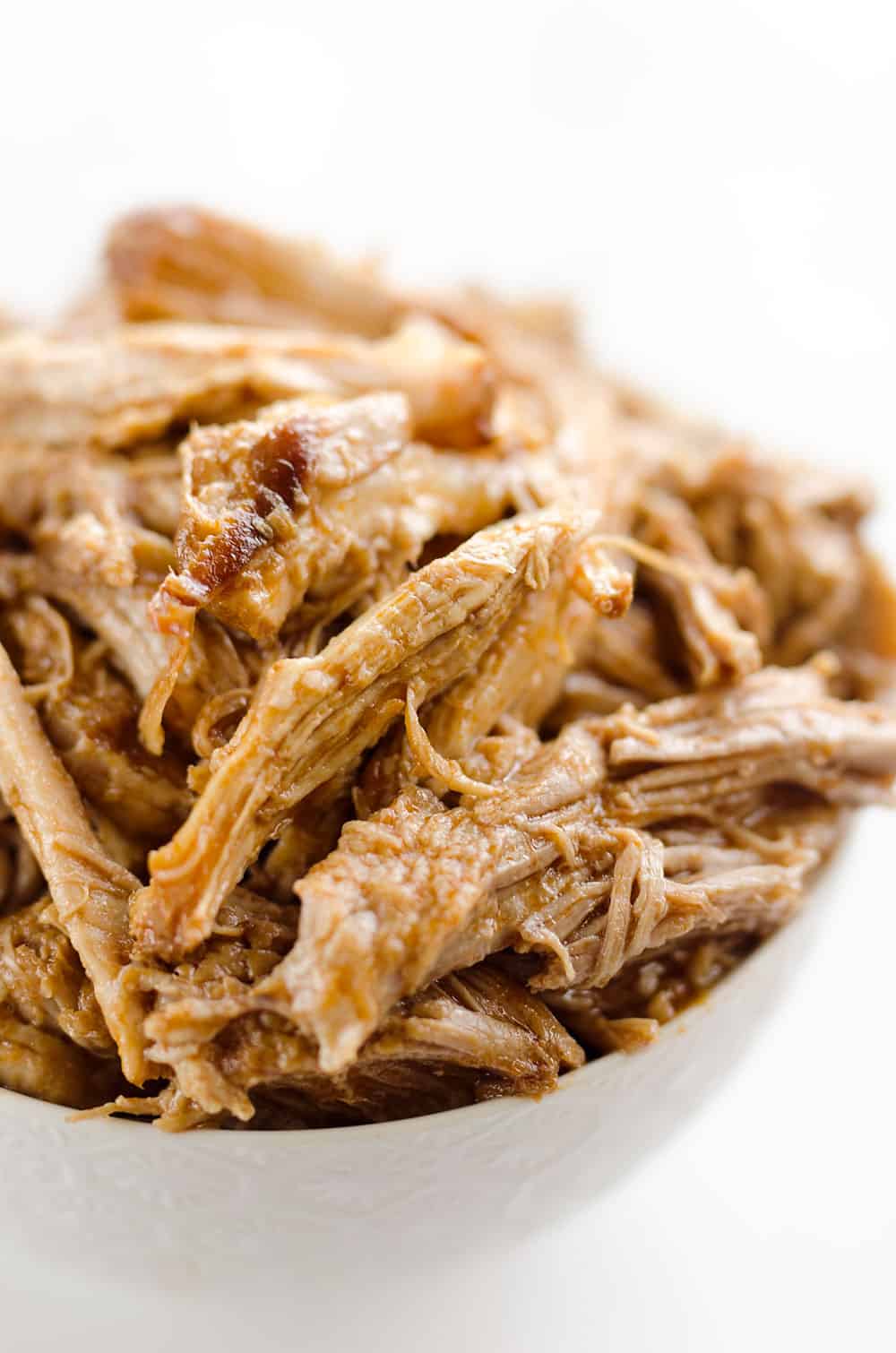 Pressure Cooker BBQ Pulled Pork is an easy three ingredient recipe that makes for tender and delicious pork that is perfect for sandwiches or wonderful paired with rice and vegetables for a healthy dinner idea.