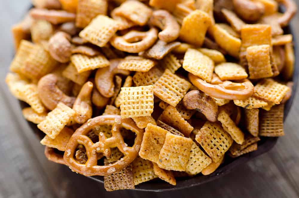 Buffalo Ranch Snack Mix is an easy treat perfect for the big game or holidays. Chex Mix is combined with pretzels and cashews and tossed in a spicy buffalo ranch sauce for a twist on your traditional snack mix.