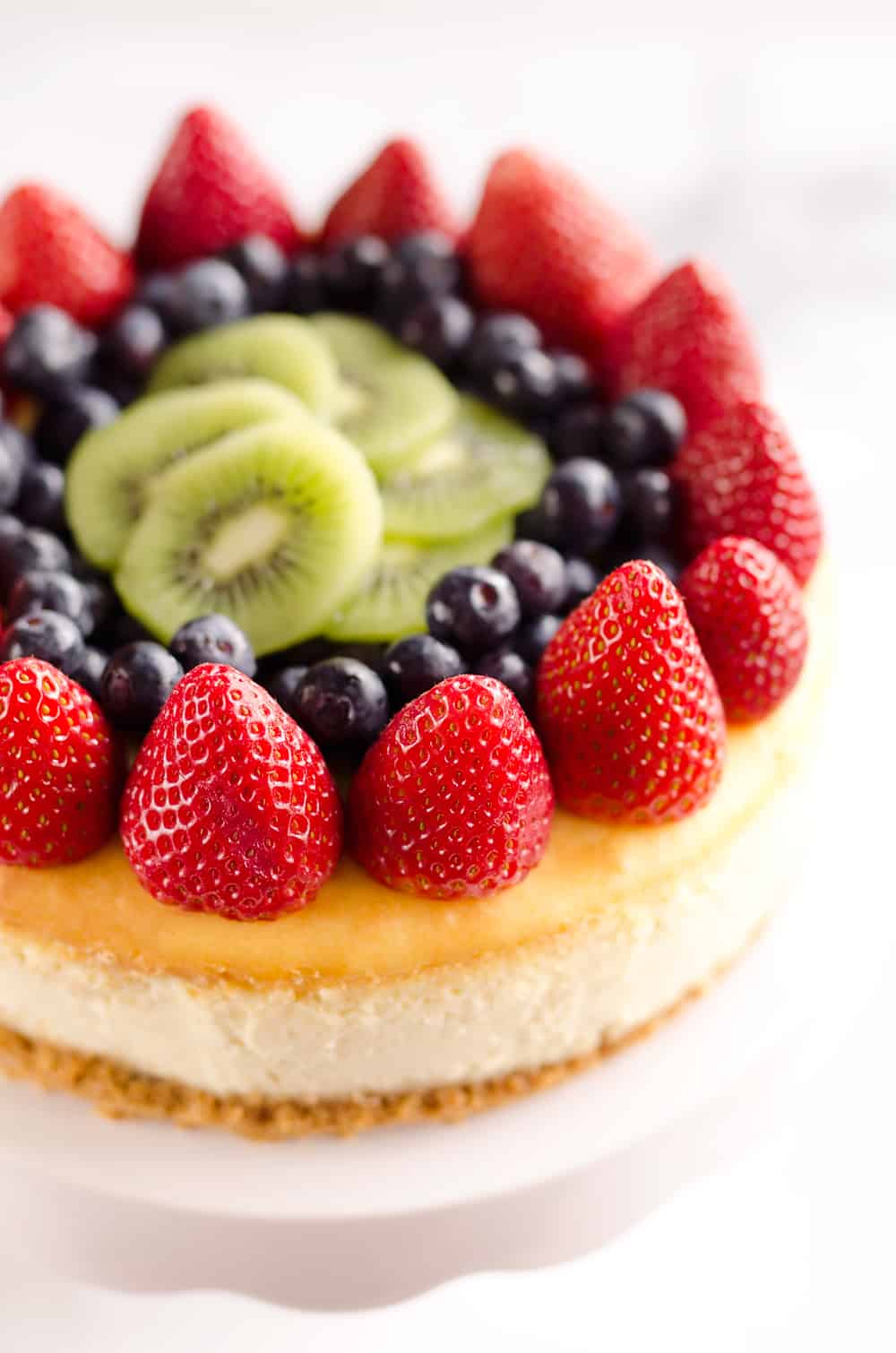 Creamy New York Cheesecake with Fresh Fruit is a rich and decadent dessert recipe that is sure to impress all your dinner guests!