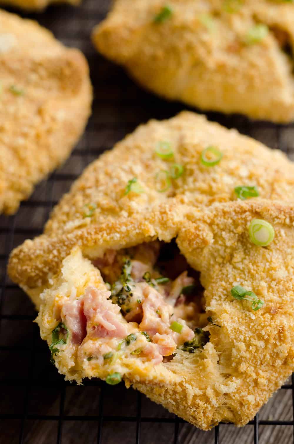 Cheesy Hot Ham & Broccoli Crescent Pockets are a family friendly dinner idea perfect for using up leftover ham! Flaky crescents are filled with a cheddar, broccoli and ham mixture and topped with buttery croutons.