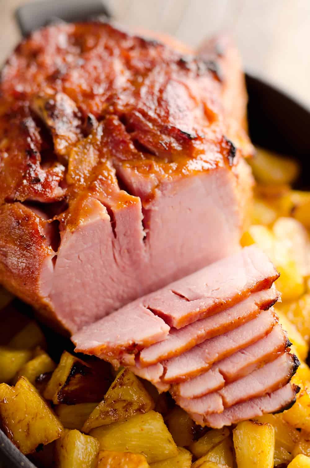 Roasted Pineapple & Chipotle Honey Ham is a sweet and spicy twist on your traditional holiday meal. This easy recipe is finished off with fresh pineapple roasted to sweet perfection for a perfect compliment to the salty and smoky ham.