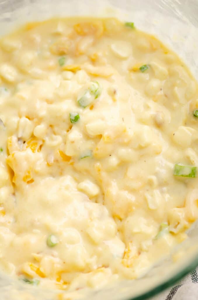 cheesy sweet corn fritter batter in glass bowl