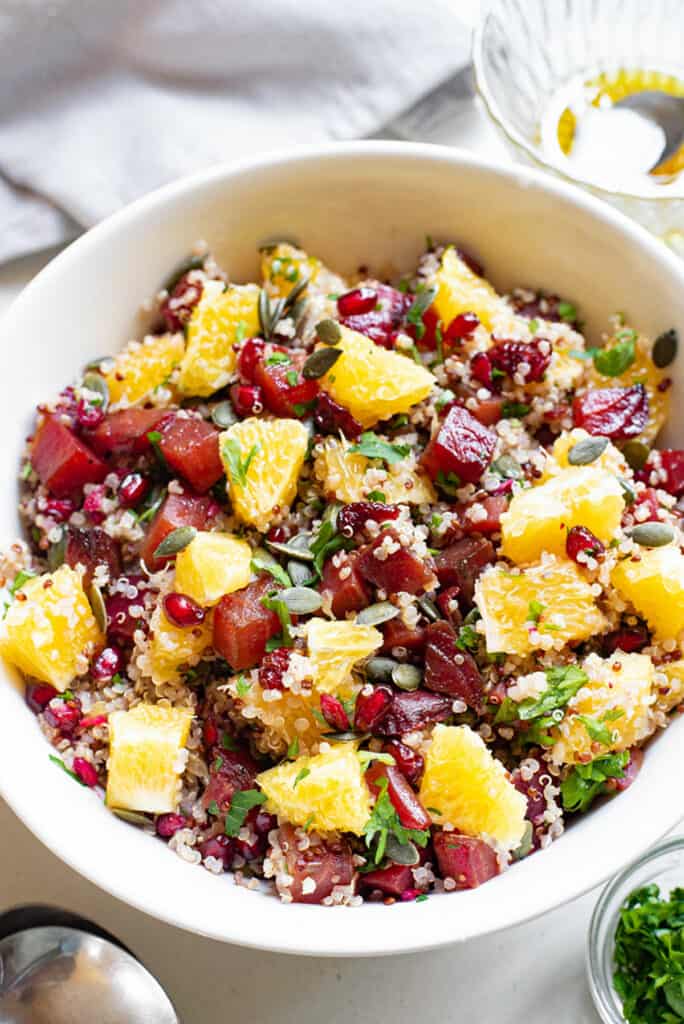 quinoa fruit and beet salad in bowl on table